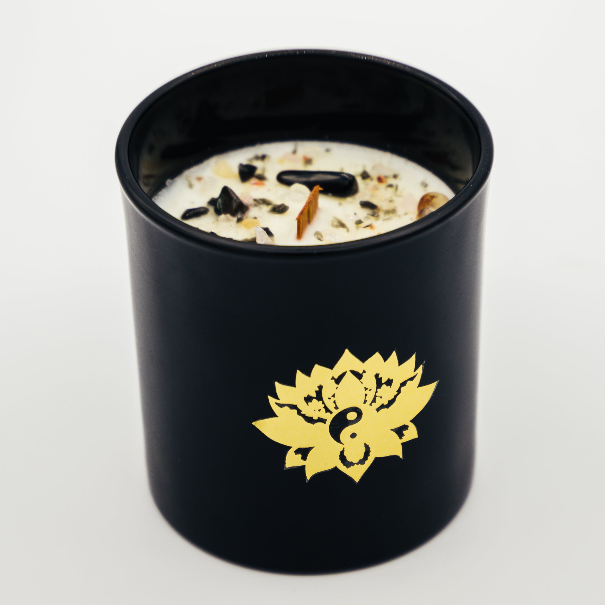 Candela con cristalli in contenitore nero decorato con un simbolo di loto dorato