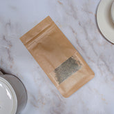 Pacchetto di tisana quarto chakra in carta marrone, perfetto per la meditazione e il benessere