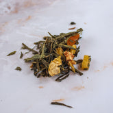 Tisana secondo chakra con foglie verdi e fiori essiccati per equilibrio energetico